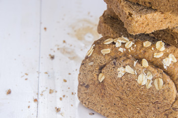 Fresh whole grain bread on white wood background