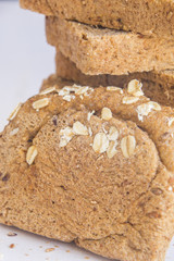 Fresh whole grain bread on white wood background