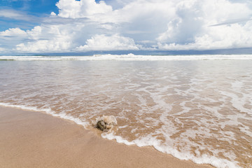 Waves sand beach and clouds sunny day