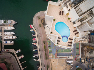 Aerial view of pool of water on the roof of a skyscraper in Dubai, UAE