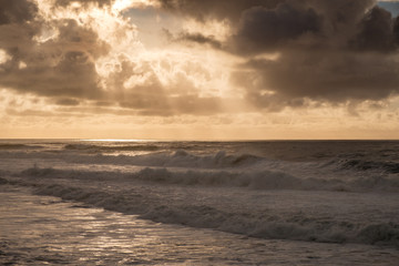 Fototapeta na wymiar Storm clouds at sunset over a rough ocean