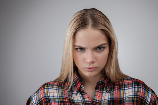 Portrait of a angry young beautiful hipster blonde teenage, Isolated on white background