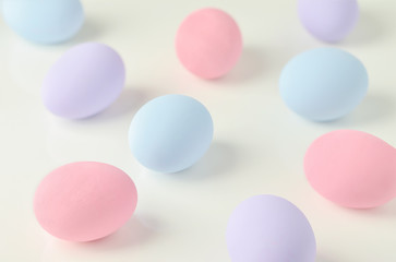 Beautiful pastel easter eggs on white table background