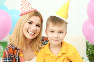 Birthday party. Portrait of mother and little son