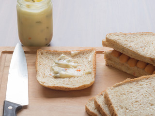 Breakfast with bread and sausage on the cutting board