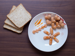 Breakfast with bread and heart sausage on the table