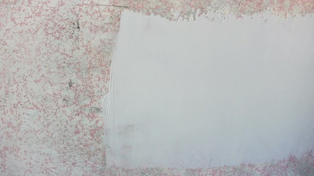 Builder with trowel putty spackling wall. Repairs work