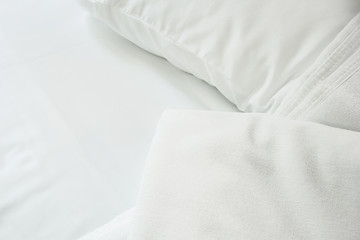 Fototapeta na wymiar white towel on white mattress fabric, soft light in the morning