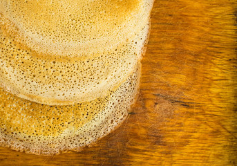 Thin Pancakes on a Wooden Background Top View