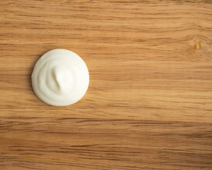 Sour Cream Swirl or White Yogurt on a Wooden Background