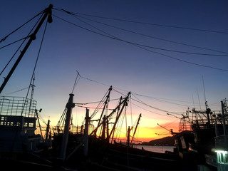 Atmospheric sunset at the fishing boat  