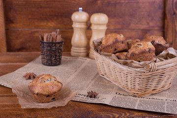 muffins with raisins on wooden background