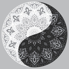 Drawing of a black and white mandala (round ethnic ornament) in shape of symbol yin yang