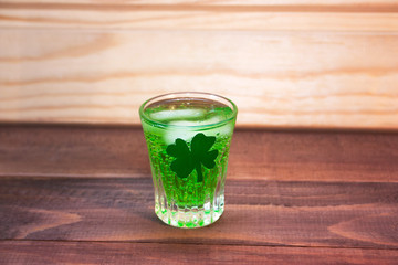 green cocktail on St. Patrick's day on a wooden background