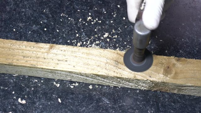 carpenter sanding piece of wood with sander machine