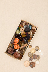 Overhead of Box of Clothing Buttons with Copy Space