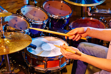 Fototapeta na wymiar Close Up Of Drummer Playing Drum Kit In Studio