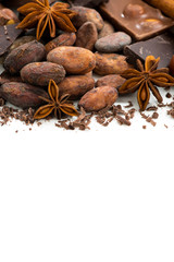 background with cocoa beans, various chocolate and spices, vertical, isolated