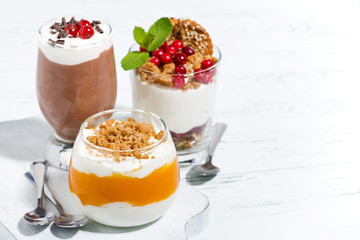 desserts with pumpkin, chocolate and biscuits on white table