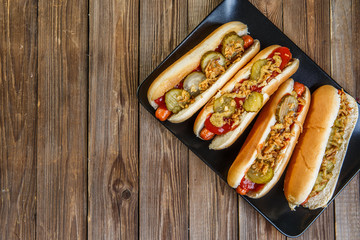 American hot dog with pickles,onions, ketchup and mustard