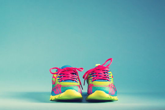 Colorful running sneakers on a blue background