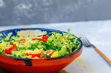 Green salad with couscous, avocado and fish.