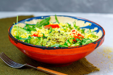 Green salad with couscous, avocado and fish.