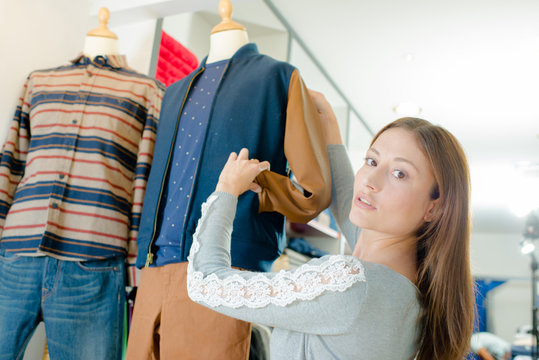 woman putting clothes on the mannequin