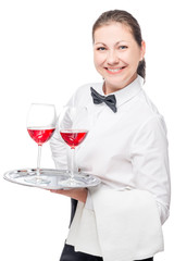 successful waitress with alcohol in glasses on a tray on a white background isolated