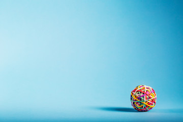 Rubber band ball on blue background