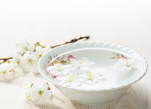 Floating flowers ( Cherry blossom) in white bowl.