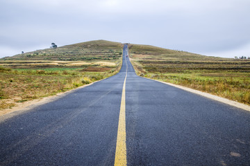 asphalt road on grassland