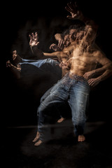 Fototapeta na wymiar Strobo portrait of shirtless wrestler man . Black background