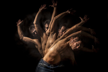 Strobo portrait of shirtless handsome man . Black background