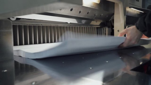 Printing press, paper cutting on the cutting machine, printing production. 4k footage.
