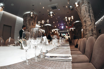 Wedding. Banquet. The chairs and table for guests, served with cutlery and crockery.