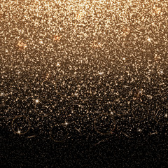 Brilliant background with abstract light. Golden dust particles on a black backdrop.
