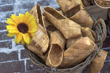 Wicker birch bark bast shoes in a basket
