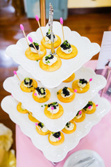 Canapes with smoked salmon and caviar on white plate