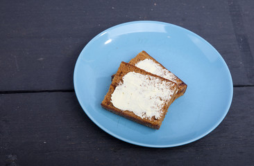 Traditional Dutch cake Ontbijtkoek with traditional butter on wooden background