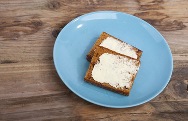 Traditional Dutch cake Ontbijtkoek with traditional butter on wooden background