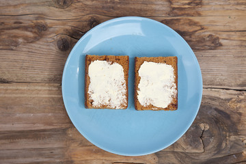 Traditional Dutch cake Ontbijtkoek with traditional butter on wooden background