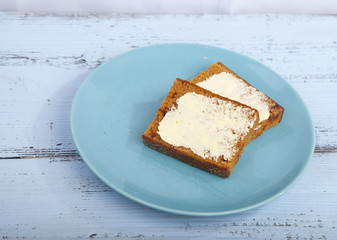 Traditional Dutch cake Ontbijtkoek with traditional butter on wooden background