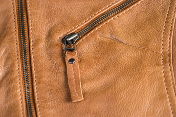 Light brown leather jacket zippers and pockets. Macro leather jacket details