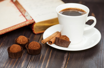 A cup of coffee with chocolate truffles