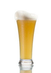 Close up of beer glass with bubbles and foam isolated on white.