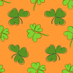 Clover seamless pattern. Clover pattern with three and four leaf green on orange background. St. Patrick's Day hand-drawn doodle style clover 