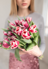 Cropped shot of unrecognizable woman holding bouquet of tulips
