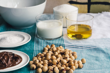 Ingredients for baking sweet cake with chocolate and hazelnuts, side view