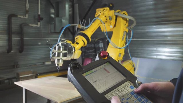Engineer Using Automated Metal-working machine. Wood carving, CNC milling machine. 3D CNC carving machine. Automated woodcarver. Carver with computer numerical control. Production of drones